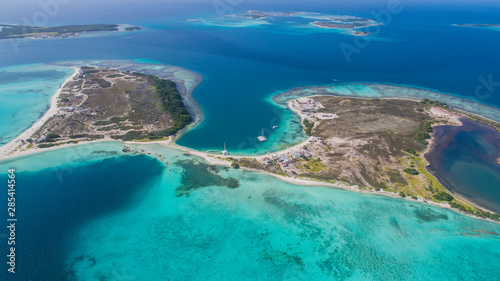 Caribbean: Vacation in the blue sea and deserted islands. Aerial view of a blue sea with crystal water. Great landscape. Beach scene. Aerial View Island Landscape Los Roques