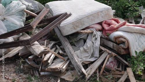 5 in 1 Garbage dumped: boards, mattress, comforter, plastic bags full of garbage