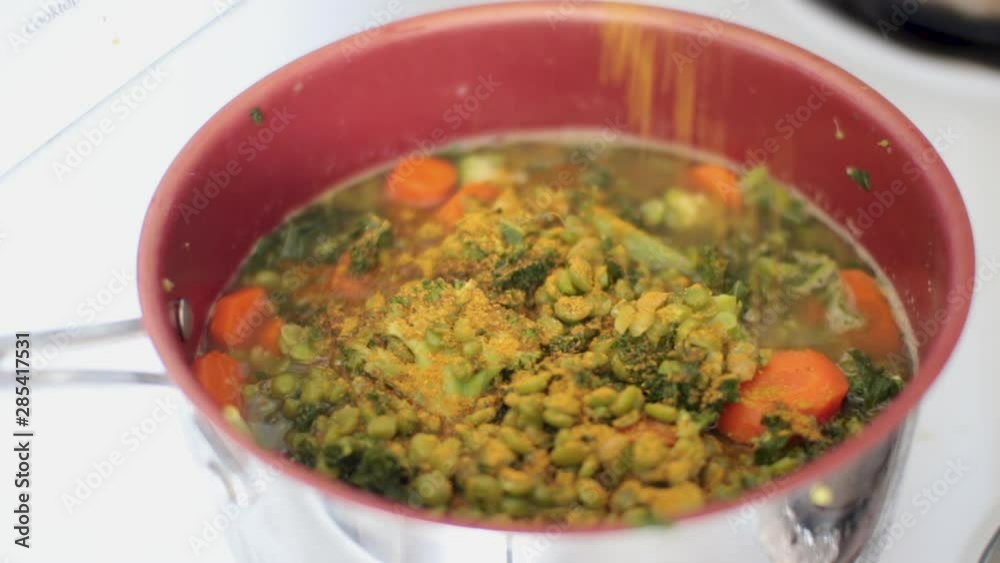 This is a close up shot of a vegetable medley consisting of peas, carrots, kale, and broccoli, all being stirred together in a non stick pan with curry and vegetable broth. This is a close up shot of a vegetable medley consisting of peas, carrots, kale, and broccoli, all being stirred together in a non stick pan with curry and vegetable broth.
