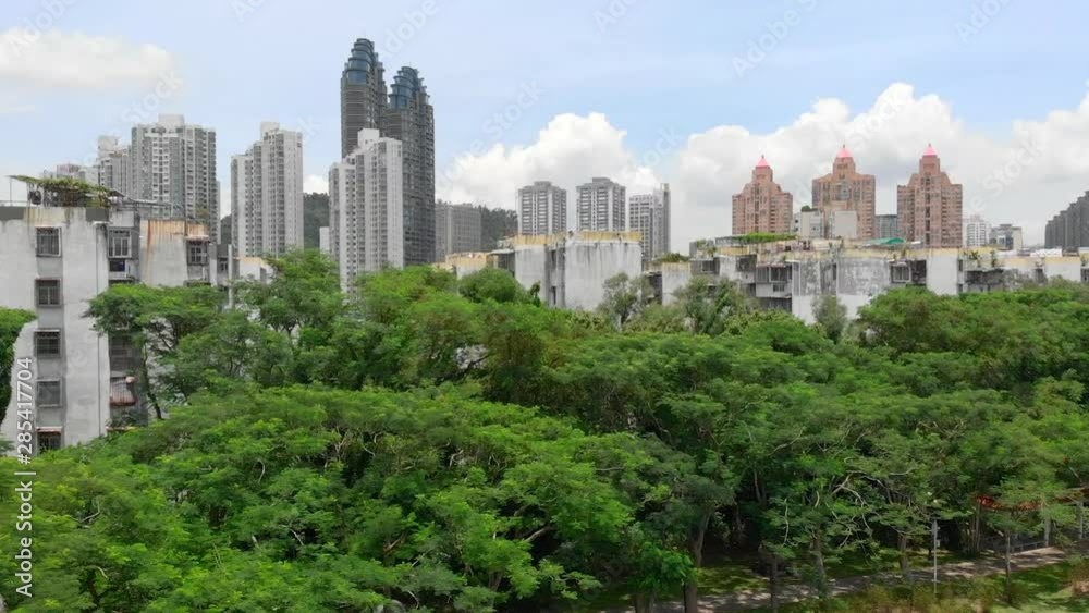 Vertical drone shot from a city park showing a contrast between nature and the cityscape of ShenZhen. Vertical drone shot from a city park showing a contrast between nature and the cityscape of ShenZhen.