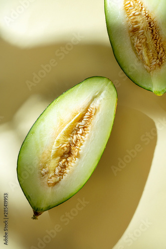 Wallpaper Mural Creative photo of cuttes tasty melon on yellow background with shadows. Close up view on sweet summer fruit melon. Food photo concept. Art work with Watermelon. Top view. flat lay Torontodigital.ca