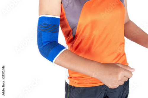 Female wearing elbow support because of injury from exercise, health care concept.