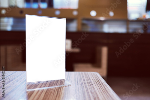 Mock up Menu frame standing on wood table in Bar restaurant cafe. space for text © Charlie's