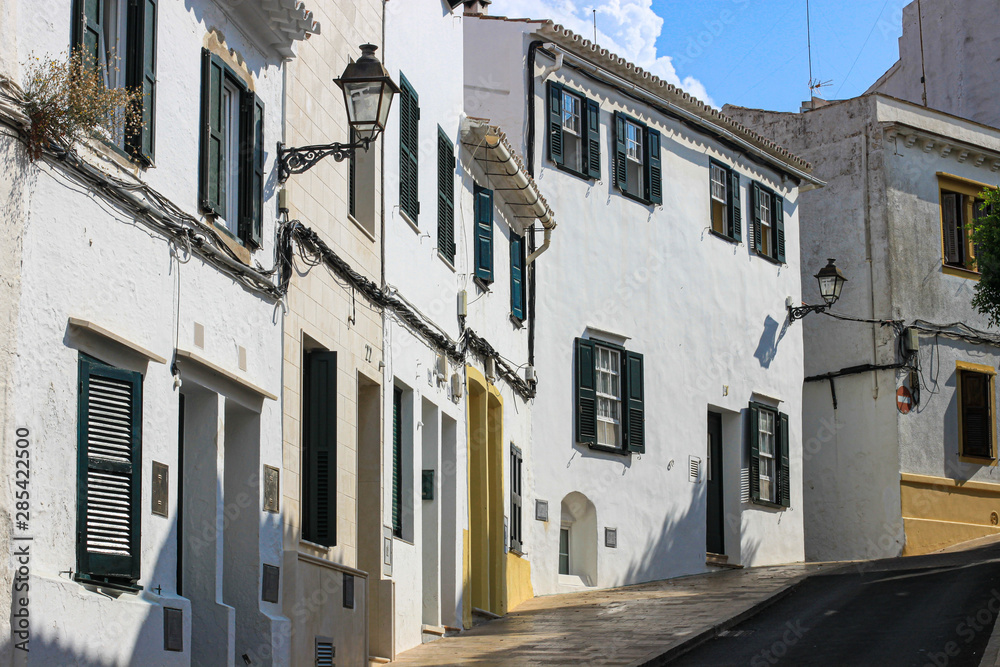 Empty street with whitewashed houses in Alaior town, Alaior, Menorca, Spain