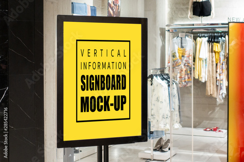 Mock up signboard in black frame at showcases fashion clothing