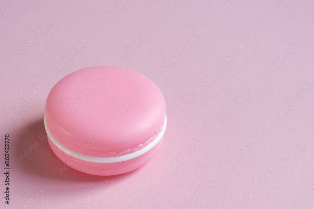 Cosmetic cream in the form of a macaroni cake on pink with place for text. Concept of beauty, makeup, femininity, fashion Cosmetic cream in the form of a macaroni cake on pink with place for text. Concept of beauty, makeup, femininity, fashion
