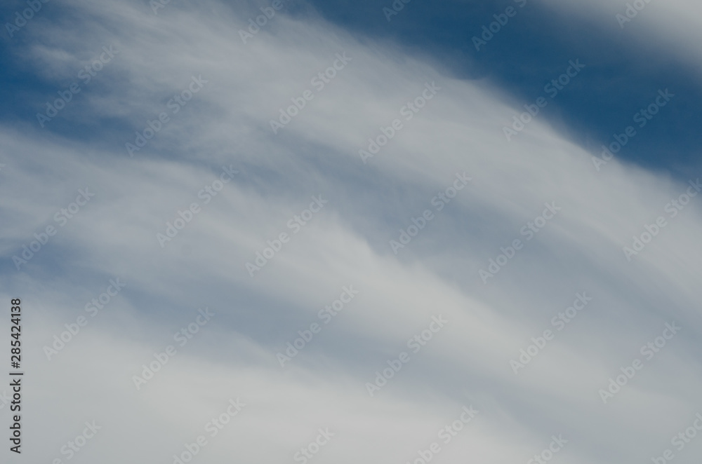clouds in the form of stripes on a background of blue sky clouds in the form of stripes on a background of blue sky