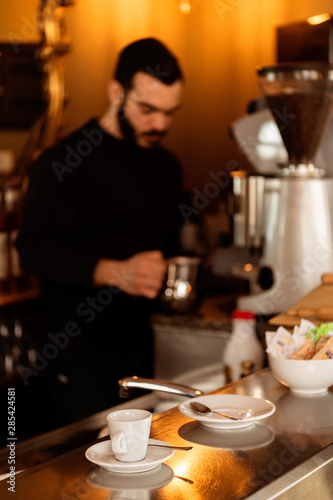 Bar counter with barman preparing coffee