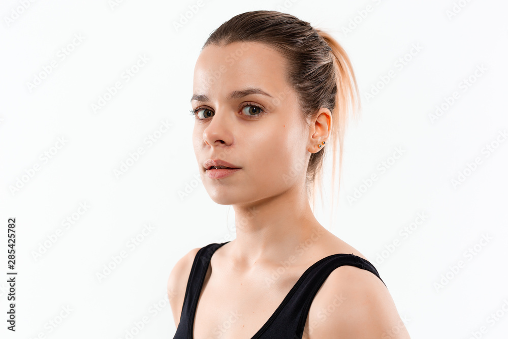 Young sporty blond woman in a black sportswear exercising isolated over white background. Young sporty blond woman in a black sportswear exercising isolated over white background.