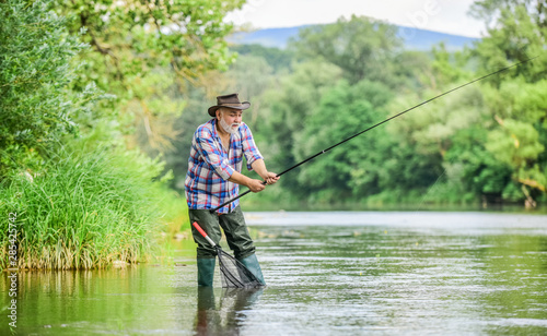 Mature man fishing. Male leisure. Fisherman with fishing rod. Senior man catching fish. Activity and hobby. Fishing freshwater lake pond river. Happiness is rod in your hand. Retired fisherman