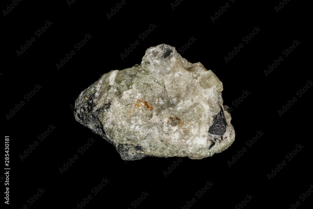 Macro stone Apatite and magnetite mineral on parade on black background Macro stone Apatite and magnetite mineral on parade on black background