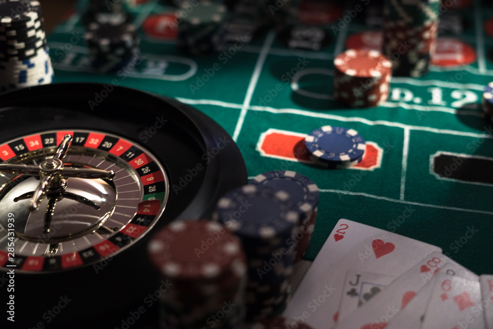 Roulette table and stack of poker chips, Casino, gambling and entertainment concept photo Roulette table and stack of poker chips, Casino, gambling and entertainment concept photo