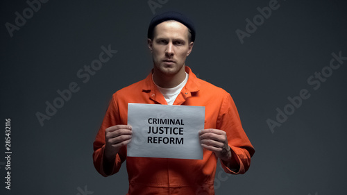 Fotografering Male prisoner holding Criminal justice reform sign, human rights protection