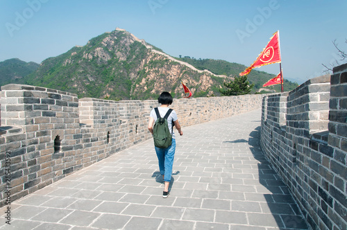 Chinese woman walking on the great wall of china