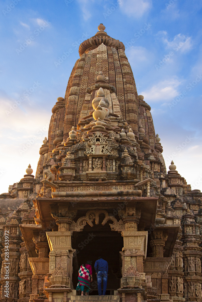 Unrecognizable tourists visiting the Khajuraho Temple, Madhya Pradesh - A world unesco heritage site