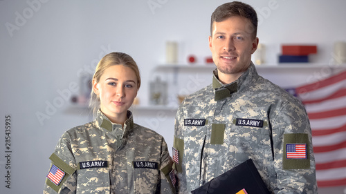 USA students of military academy with folders looking at camera, education
