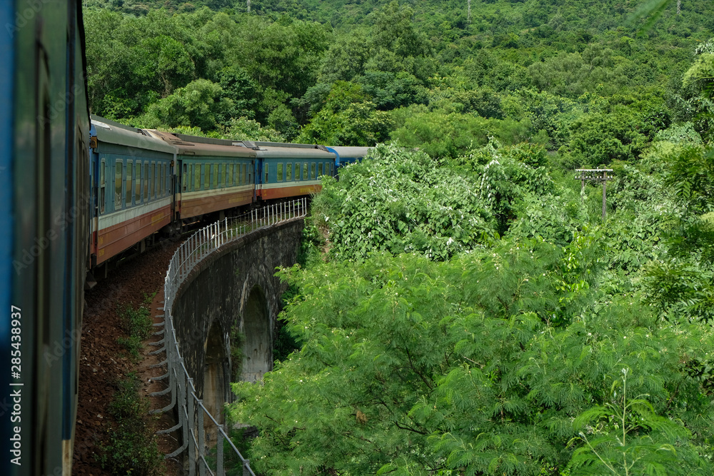 Da Nang, Vietnam - August 19: Train running through Hai Van Pass in the middle center of Vietnam on August 19, 2018 in Da Nang, Vietnam. Da Nang, Vietnam - August 19: Train running through Hai Van Pass in the middle center of Vietnam on August 19, 2018 in Da Nang, Vietnam.