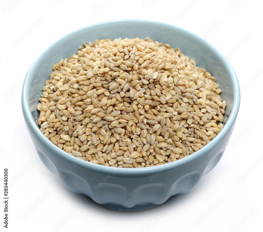 Peeled barley grains in bowl isolated on white background Peeled barley grains in bowl isolated on white background