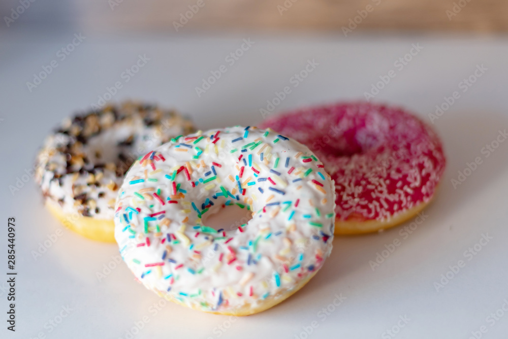 three delicious donuts on white background three delicious donuts on white background