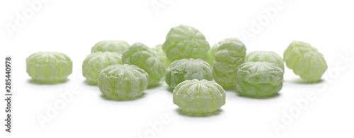 Green hard menthol candies isolated on white background