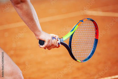 Tennis player hitting two-handed backhand. © Dmytro Panchenko