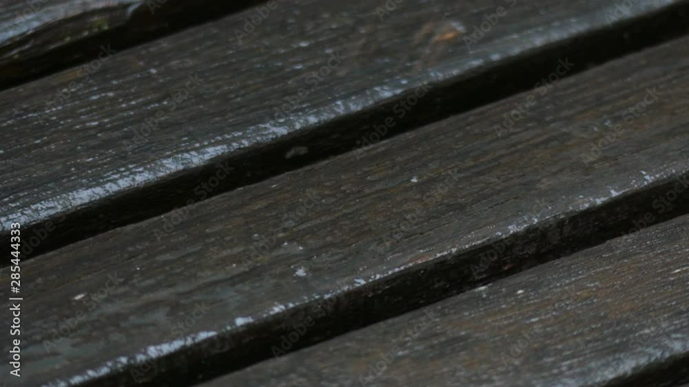 Fresh snow falling on a wooden bench Fresh snow falling on a wooden bench