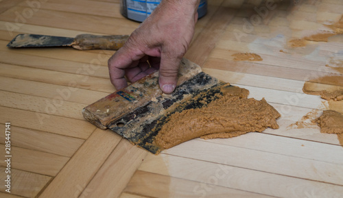 Man grouting parquet