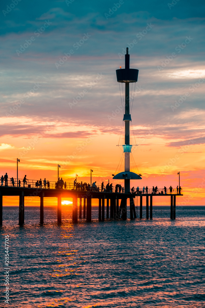 Brighton jetty with people silhouettes at sunset, South Australia 