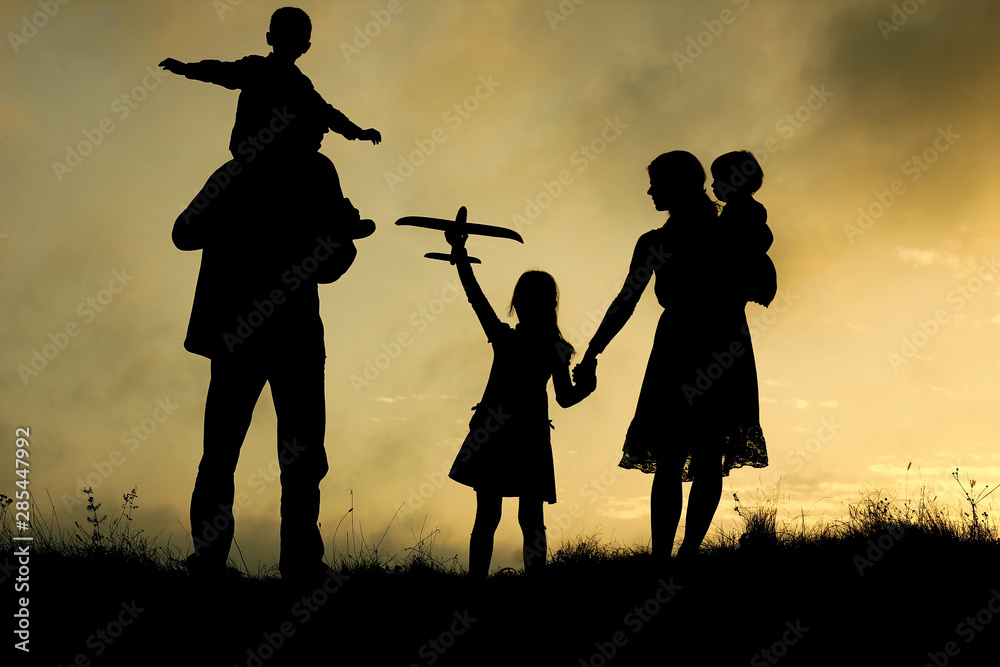 silhouette of a happy family with children