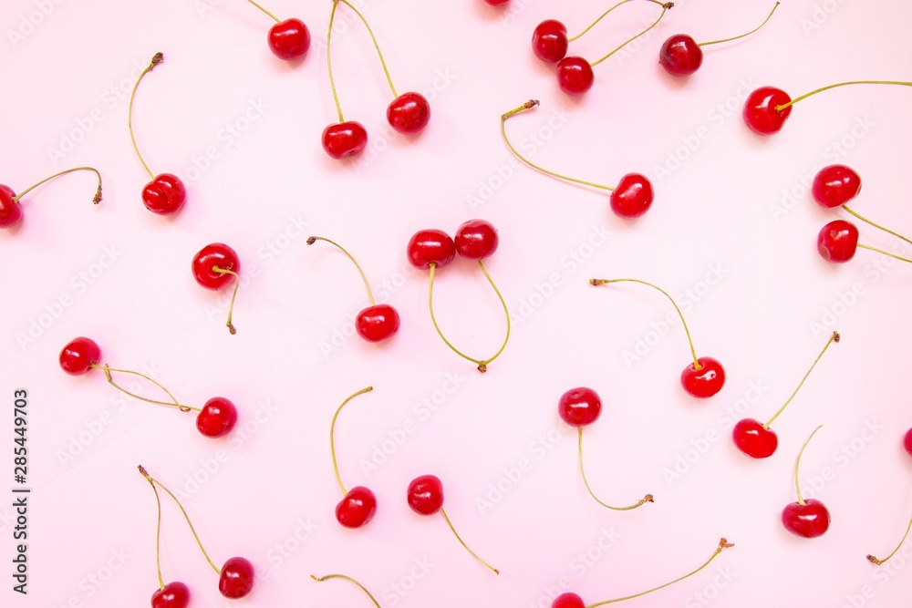 Flat lay of cherries on a pink background. Top view Flat lay of cherries on a pink background. Top view
