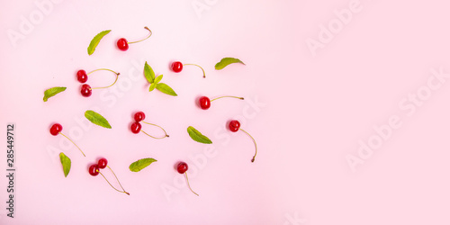 Wallpaper Mural Flat lay of cherries and leaves on a pink background.Top view Torontodigital.ca
