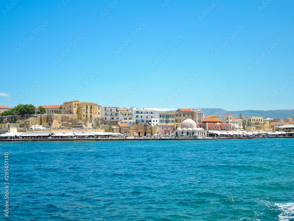View of the old harbor of Chania with horse carriages and mosque, Crete, Greece