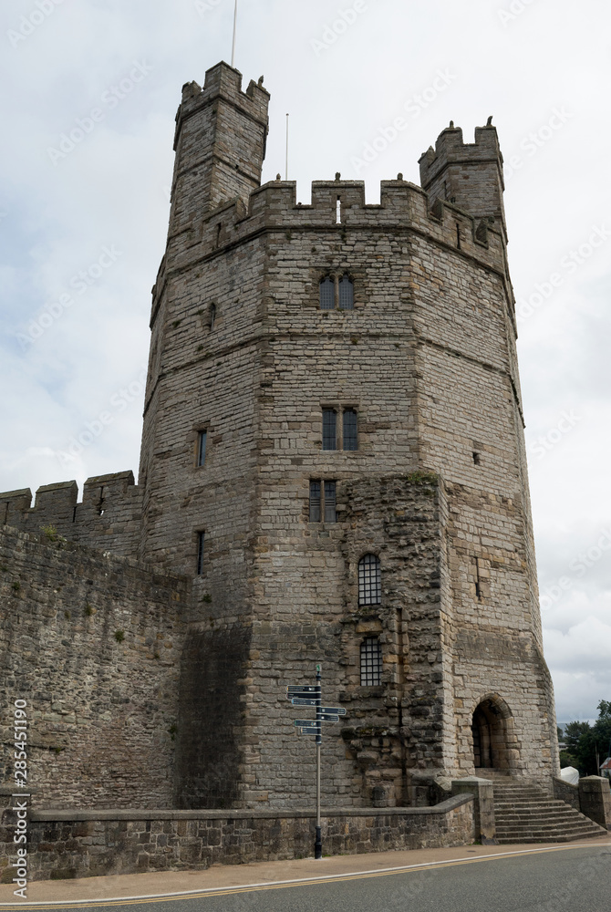 Wales, the old city of Caernarfon. The old castle. The Eagle tower. Intact medieval architecture. Turrets on the defensive walls and tower.