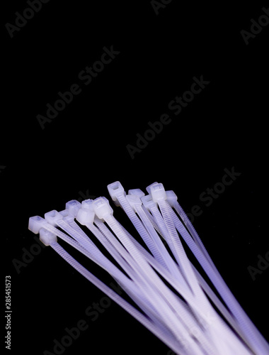 heap of black cable ties on white background