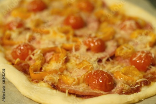 Tasty italian pizza with sasage, tomatos and cheese