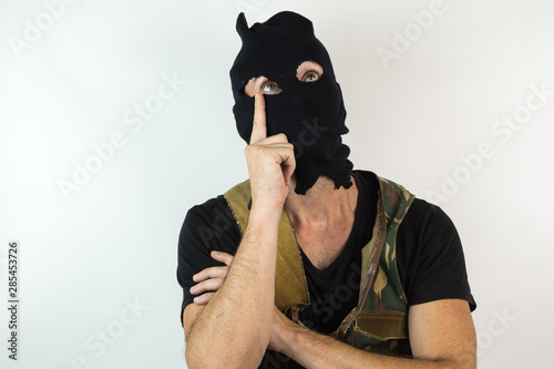 men with military vest and balaclava pensive in White background © Hector
