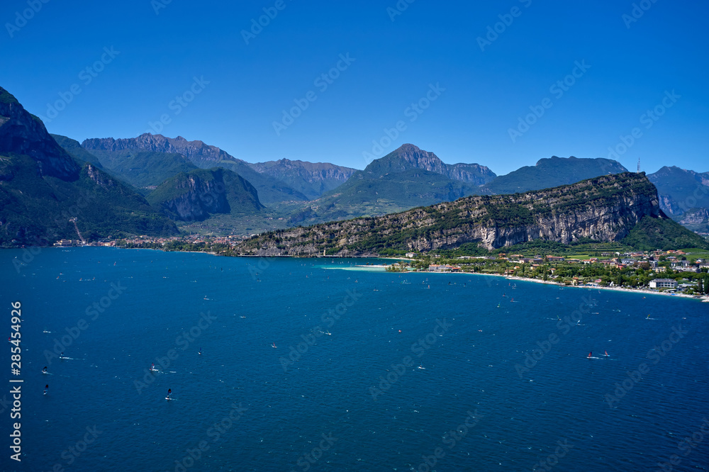 Naklejka premium Panorama of Lake Garda surrounded by mountains in Riva del Garda, Italy. Lake Garda Italy. Aerial view