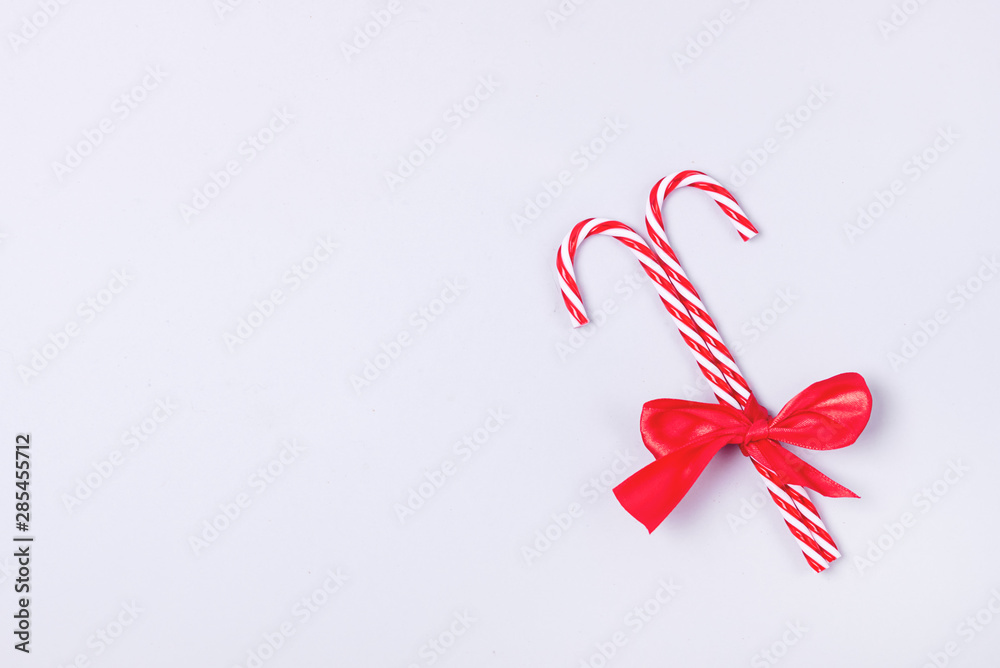 Two Candy Cane Tied a Red Ribbon on Blue Background Christmas Background Top View Copy Space
