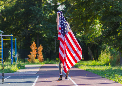 Sport: Young woman in sportswear with the American flag.