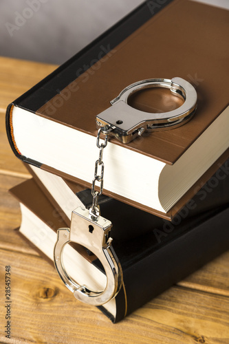 Close-up with handcuffs on books