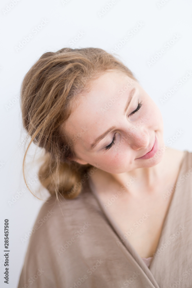 Attractive, beautiful young girl with brown hair on a white background. The concept of student life, youth. Attractive, beautiful young girl with brown hair on a white background. The concept of student life, youth.