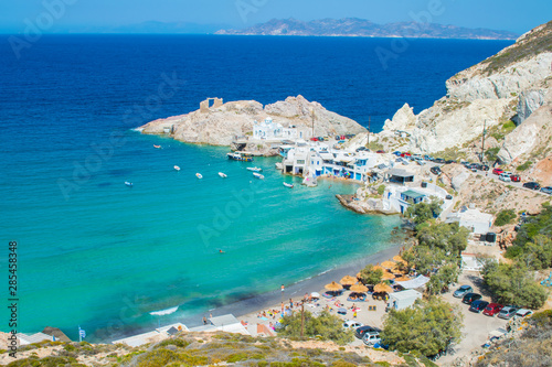 Panoramic view of the beach of Firopotamos village eith the turquoise waters and the colorful fishing houses