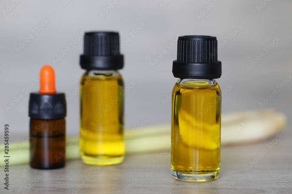 Peppermint essential oil in glass bottles on wooder background Peppermint essential oil in glass bottles on wooder background