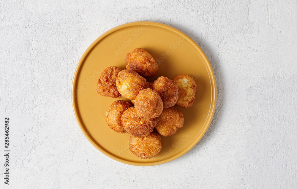 Cottage cheese balls doughnuts is jam-packed with jelly filling on yellow plate
