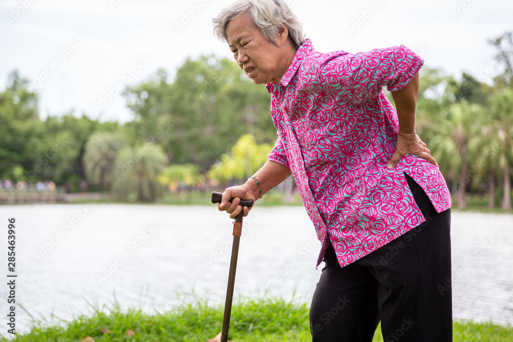 Asian senior woman with hip joint pain while walking ,female patient