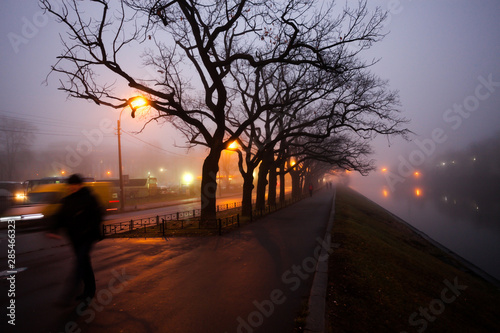 The sad autumn city view with yellow lanterns