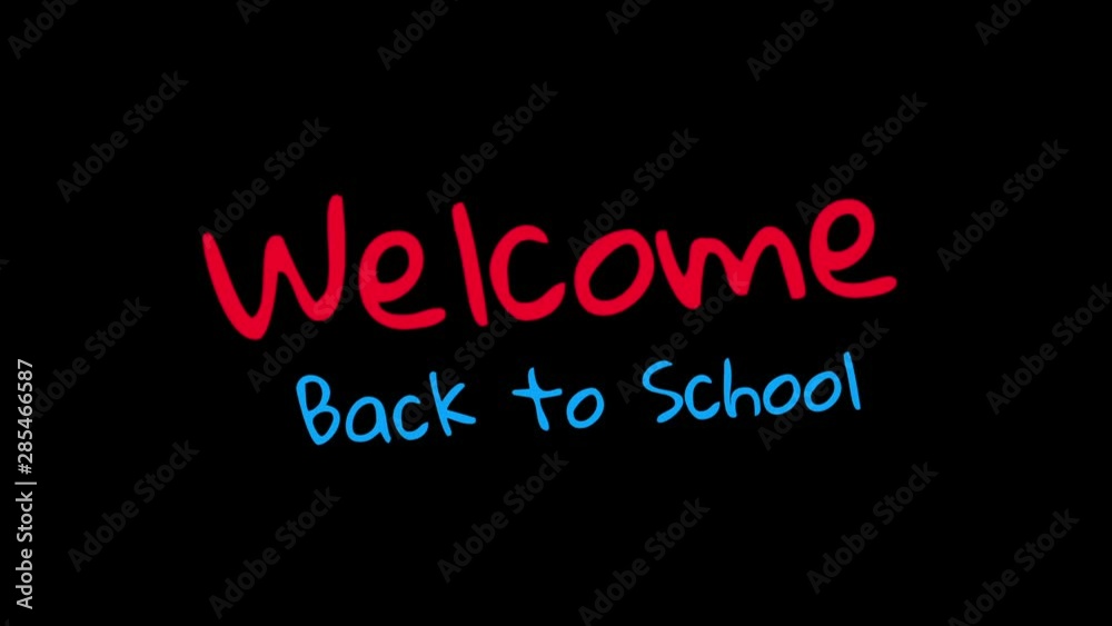 Welcome back to school handwritten on black background Welcome back to school handwritten on black background