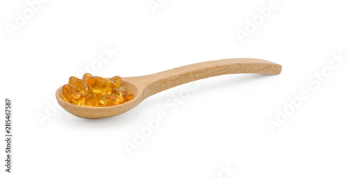 Vitamin pills and oil filled capsules (soft gel) in wooden spoon isolated on white background, Dietary supplement healthcare product Clipping part.