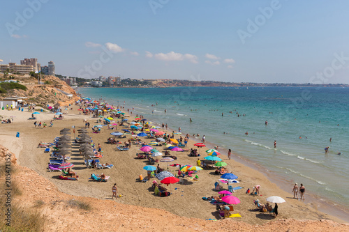 Playa Vistamar beach Mil Palmeras Costa Blanca Spain with people sunbathing on the beach in beautiful weather
