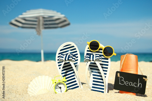 Family slippers on the sand on the beach